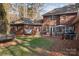 Expansive brick home backyard featuring a grassy lawn, patio, and mature trees for added privacy at 102 Wyndham Way, Salisbury, NC 28147