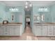 Large bathroom with dual sinks, lots of lighting, a neutral tile floor and fresh paint at 102 Wyndham Way, Salisbury, NC 28147