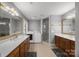 Bright bathroom featuring double vanities, tile floors, walk-in shower, and laundry setup at 102 Wyndham Way, Salisbury, NC 28147