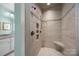 Tiled bathroom featuring a walk-in shower with multiple shower heads and built-in niche shelving at 102 Wyndham Way, Salisbury, NC 28147