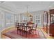 Bright dining room with hardwood floors, chandelier, and large windows with white shutters at 102 Wyndham Way, Salisbury, NC 28147