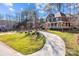 Beautiful brick home with lush landscaping and a winding driveway on a spacious lot surrounded by mature trees at 102 Wyndham Way, Salisbury, NC 28147