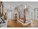 Elegant foyer with hardwood floors, staircase and decorative rug creates a grand and welcoming entrance at 102 Wyndham Way, Salisbury, NC 28147