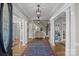Elegant foyer with hardwood floors, decorative rug, staircase and chandelier creates a grand and welcoming entrance at 102 Wyndham Way, Salisbury, NC 28147