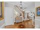 Elegant foyer with hardwood floors, staircase and decorative rug creates a grand and welcoming entrance at 102 Wyndham Way, Salisbury, NC 28147