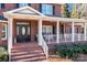 Inviting front porch with brick flooring, white railings, and comfortable seating, perfect for relaxing outdoors at 102 Wyndham Way, Salisbury, NC 28147