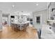 Open-concept kitchen featuring an island with seating, stainless steel appliances, and hardwood floors at 102 Wyndham Way, Salisbury, NC 28147