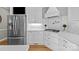 Bright kitchen featuring stainless steel appliances, white cabinetry, tile backsplash and hardwood floors at 102 Wyndham Way, Salisbury, NC 28147