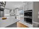 Bright kitchen featuring stainless steel appliances, white cabinetry, a farmhouse sink and hardwood floors at 102 Wyndham Way, Salisbury, NC 28147