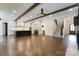 Spacious living room featuring hardwood floors, exposed beams, and lots of natural light at 106 Pecan Cove Ln, Weddington, NC 28104