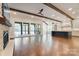 Open-concept living space featuring a fireplace, hardwood floors, and a view of the backyard at 106 Pecan Cove Ln, Weddington, NC 28104