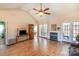 Open living room featuring a fireplace, hardwood floors, and natural light from a pair of French doors at 1114 Setter Ln, Concord, NC 28025