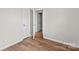 An empty bedroom shows a doorway to another room and hardwood floors at 114 Downing St, Troutman, NC 28166