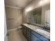 Bathroom featuring double sink vanity with granite countertops, modern lighting, and walk-in shower at 11533 Valley Oaks Ln, Stanfield, NC 28163