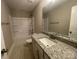 Full bathroom featuring granite countertops, large mirror, shower and tub combo at 11533 Valley Oaks Ln, Stanfield, NC 28163