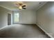 Large bedroom features soft carpeting, a window, and decorative molding at 11533 Valley Oaks Ln, Stanfield, NC 28163