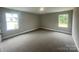 Bright bedroom with neutral walls, soft carpeting, and large windows providing plenty of natural light at 11533 Valley Oaks Ln, Stanfield, NC 28163