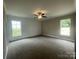 Spacious bedroom featuring neutral color palette, plush carpet, ceiling fan, and natural light at 11533 Valley Oaks Ln, Stanfield, NC 28163