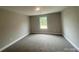 Bedroom featuring neutral walls, plush carpet, and large windows providing natural light at 11533 Valley Oaks Ln, Stanfield, NC 28163