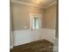 Bright entryway with wainscoting, luxury vinyl flooring, and a paneled door for a grand entrance at 11533 Valley Oaks Ln, Stanfield, NC 28163