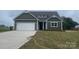 Charming craftsman-style home with an attached garage, well-manicured lawn, and beautiful curb appeal at 11533 Valley Oaks Ln, Stanfield, NC 28163