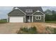Charming home featuring a green exterior, white trim, and an attached two-car garage at 11533 Valley Oaks Ln, Stanfield, NC 28163