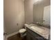 Charming half-bathroom with vanity, granite countertops, and modern fixtures at 11533 Valley Oaks Ln, Stanfield, NC 28163