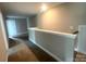 Upstairs hallway with neutral paint and carpet flooring at 11533 Valley Oaks Ln, Stanfield, NC 28163