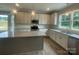 Modern kitchen featuring granite counters, stainless steel appliances, a large island, and stylish pendant lighting at 11533 Valley Oaks Ln, Stanfield, NC 28163