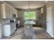 Bright kitchen features white cabinets, granite countertops, and stainless steel appliances at 11533 Valley Oaks Ln, Stanfield, NC 28163