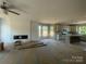 Open concept living room and kitchen area with fireplace, with lots of natural light at 11533 Valley Oaks Ln, Stanfield, NC 28163