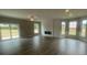 Spacious living room featuring a decorative fireplace, abundant natural light, and durable plank flooring at 11533 Valley Oaks Ln, Stanfield, NC 28163