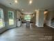 Expansive open-concept living space flowing seamlessly into the kitchen with luxury vinyl plank flooring throughout at 11533 Valley Oaks Ln, Stanfield, NC 28163