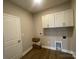 Mud room with wood-look flooring, storage cabinets, and convenient access to utilities at 11533 Valley Oaks Ln, Stanfield, NC 28163