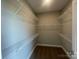 Walk-in closet with ample shelving and carpet flooring, offering plenty of storage space at 11533 Valley Oaks Ln, Stanfield, NC 28163