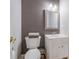 Powder room featuring a white vanity, a toilet, and neutral wall color at 11609 Mersington Ln, Charlotte, NC 28277