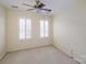 Cozy bedroom with natural light from two windows and a ceiling fan at 11609 Mersington Ln, Charlotte, NC 28277