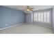 Bright bedroom with a ceiling fan and plantation shutters at 11609 Mersington Ln, Charlotte, NC 28277