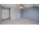 Neutral carpeted bedroom with modern ceiling fan at 11609 Mersington Ln, Charlotte, NC 28277