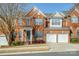 Charming brick townhome featuring a two-car garage, a covered entry, and well-maintained landscaping at 11609 Mersington Ln, Charlotte, NC 28277