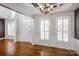 Bright foyer with hardwood floors, plantation shutters, and a view of the front door at 11609 Mersington Ln, Charlotte, NC 28277