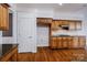 Kitchen featuring wood cabinets, granite counters, and hardwood floors at 11609 Mersington Ln, Charlotte, NC 28277