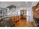 Kitchen with wood cabinets and granite countertops and a view of the stairs at 11609 Mersington Ln, Charlotte, NC 28277