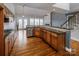 Open kitchen featuring granite counters, wood cabinets, and hardwood floors at 11609 Mersington Ln, Charlotte, NC 28277