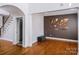 Spacious living room features hardwood floors, an archway, and a stylish accent wall at 11609 Mersington Ln, Charlotte, NC 28277
