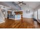 Open-concept living space with hardwood floors, and a kitchen featuring wood cabinets at 11609 Mersington Ln, Charlotte, NC 28277