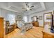 Tranquil primary bedroom suite with a tray ceiling, soft decor, and comfortable furnishings at 1221 Edgefield Rd, York, SC 29745