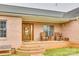 Inviting front porch with brick steps, seating, and a decorative wreath on the beautiful wooden front door at 1221 Edgefield Rd, York, SC 29745