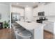 Modern kitchen with quartz countertops, stainless steel appliances, and bar stool seating at the island at 12425 Larue Ln, Huntersville, NC 28078