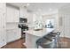 Bright kitchen featuring white cabinetry, stainless steel appliances, and a spacious island with seating at 12425 Larue Ln, Huntersville, NC 28078